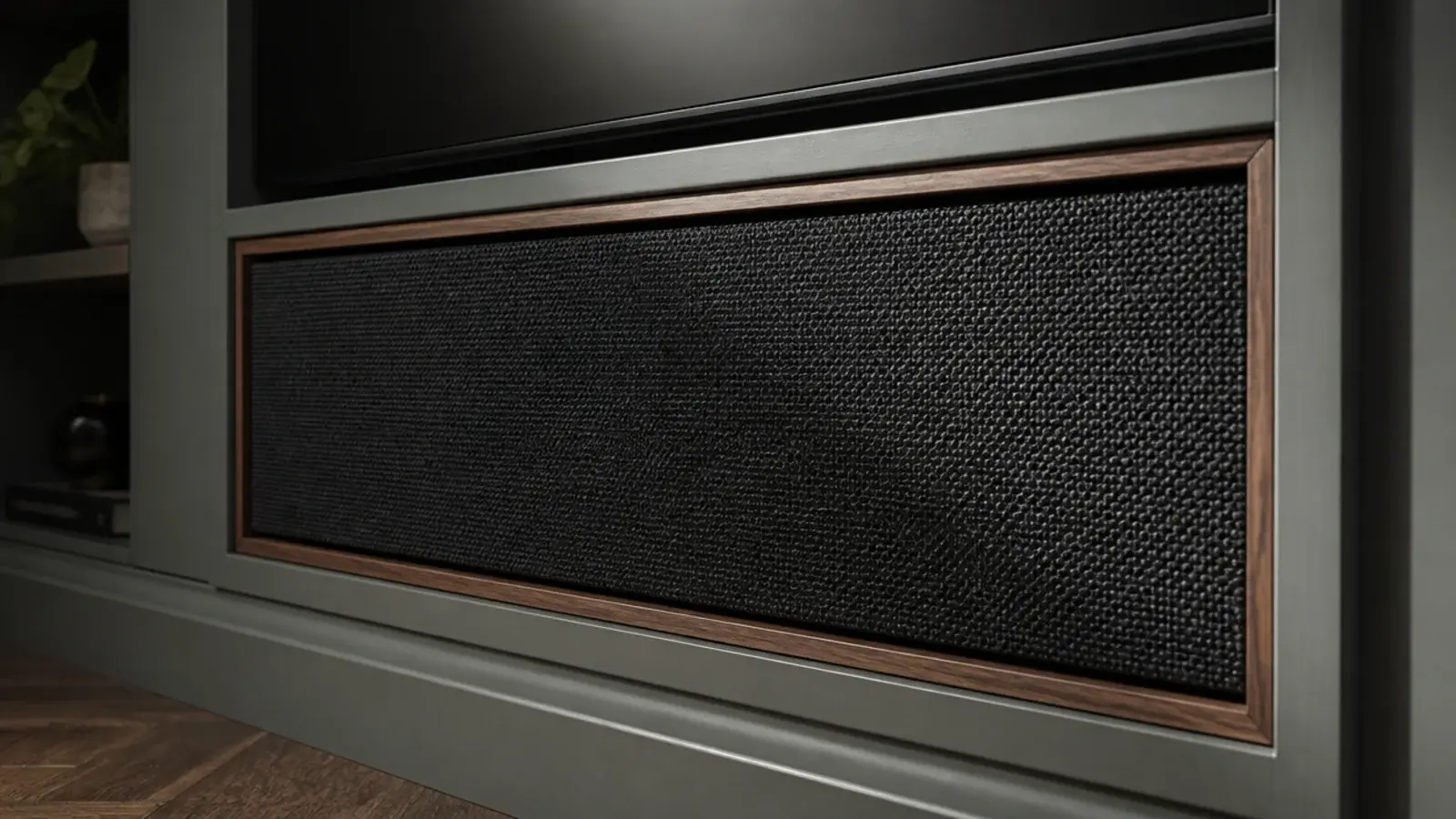 stretched fabric panel concealing a speaker within a media wall
