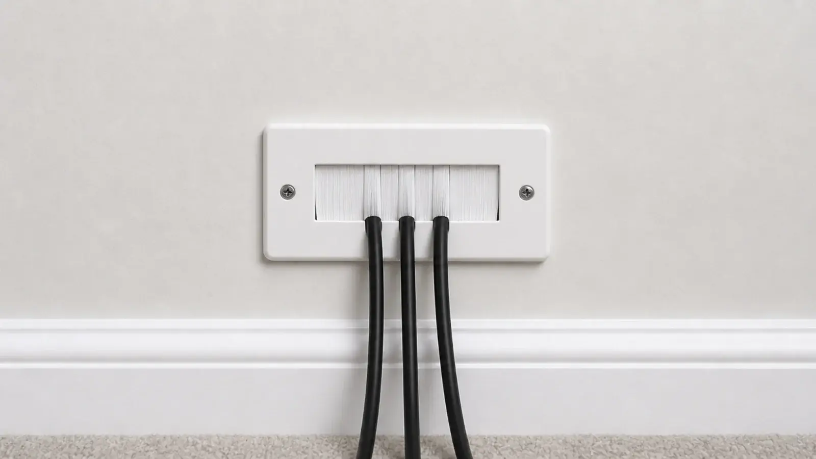 brushed cable plate set into a wall with leads passing through it