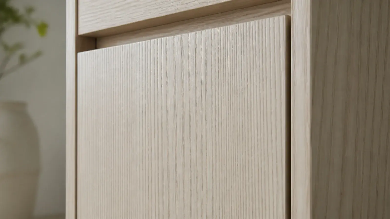pale ash cabinet front with bold open grain under a clear finish