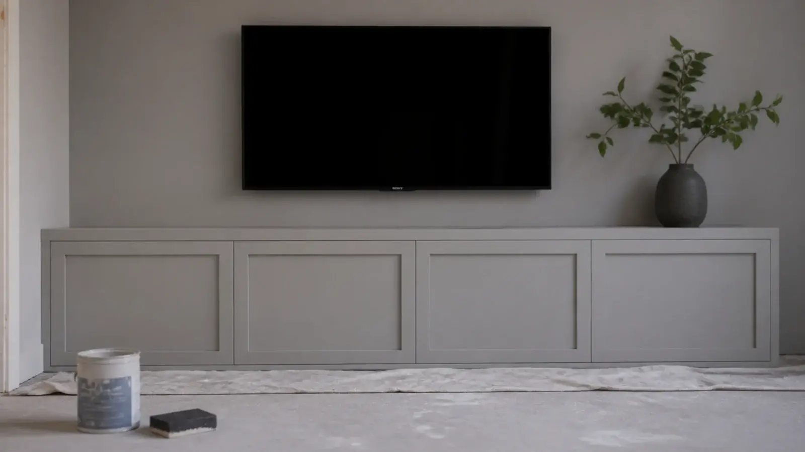 old media unit painted to match the wall so it visually disappears