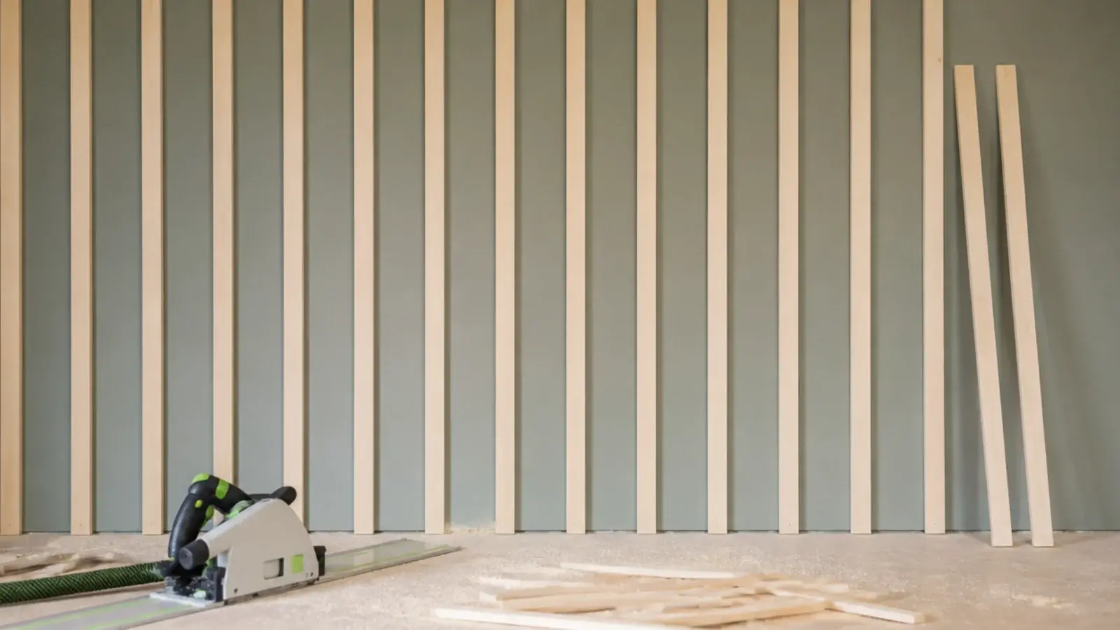evenly ripped whitewood battens fixed vertically across a painted wall