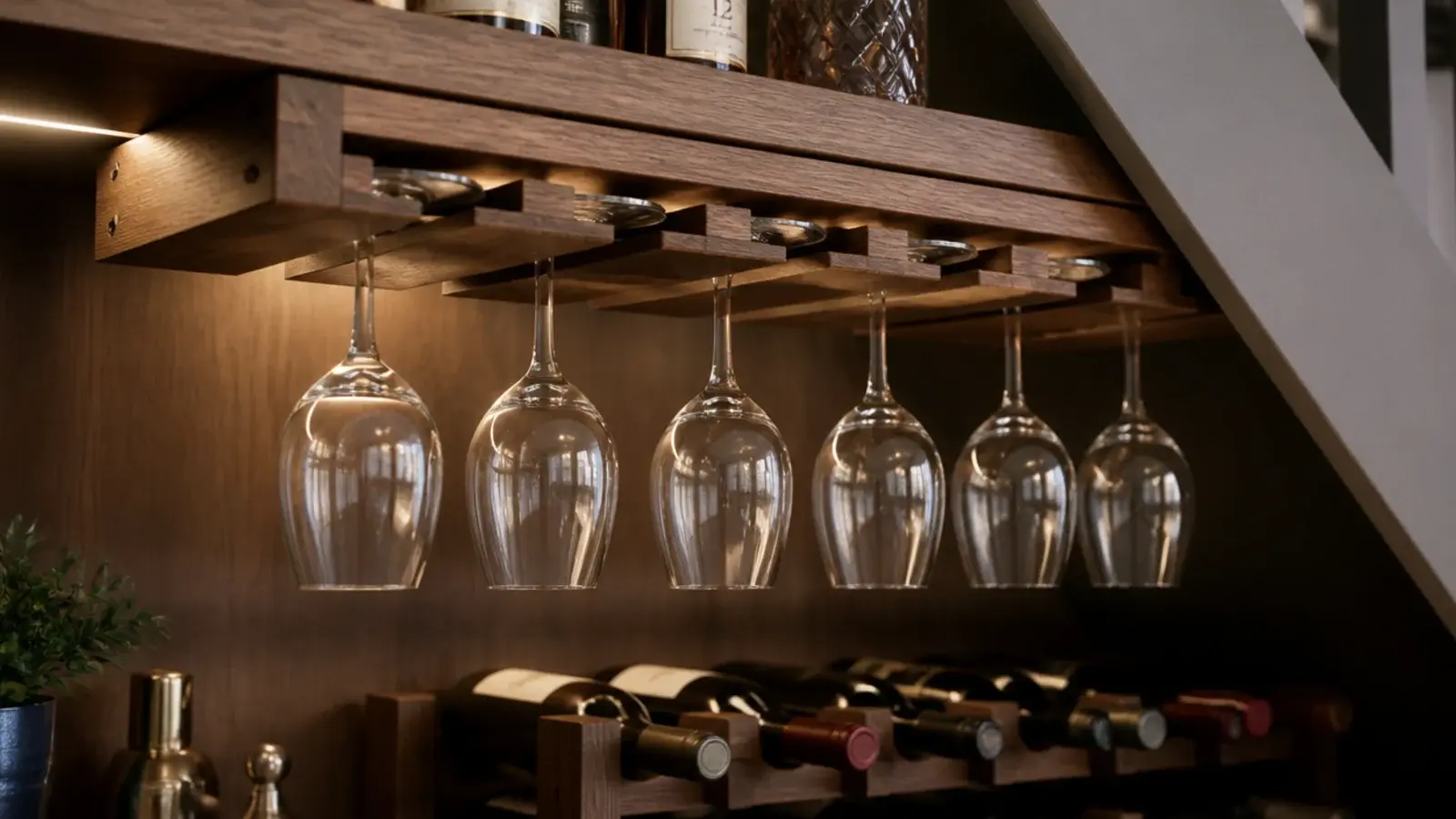 wine glasses hanging upside down from a timber stemware rack