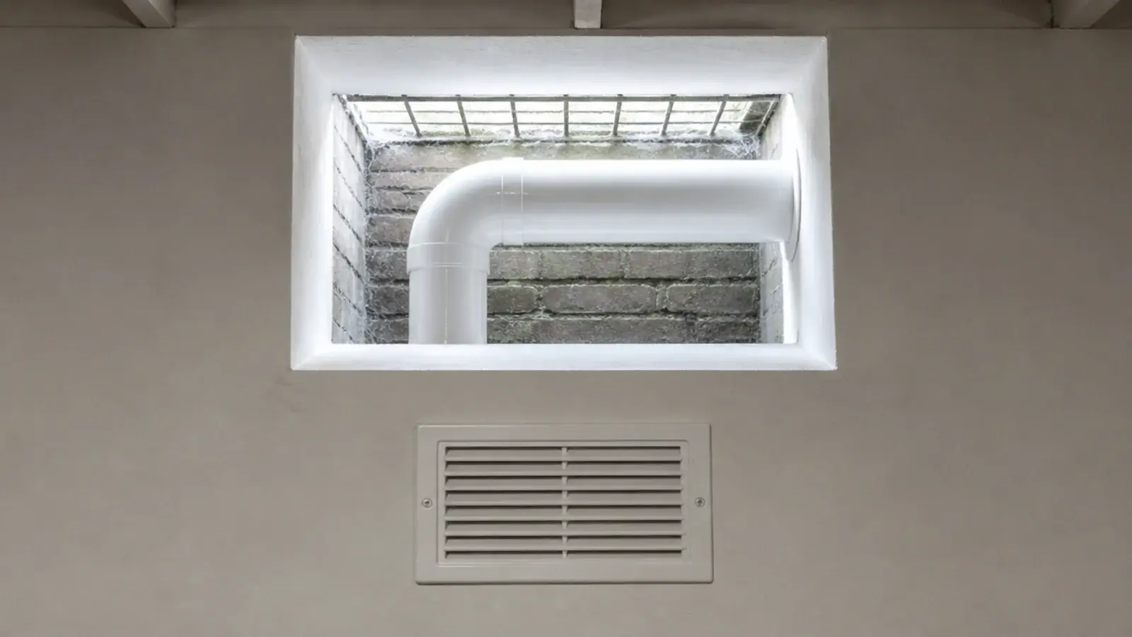 extractor duct passing through a basement light well to outside air