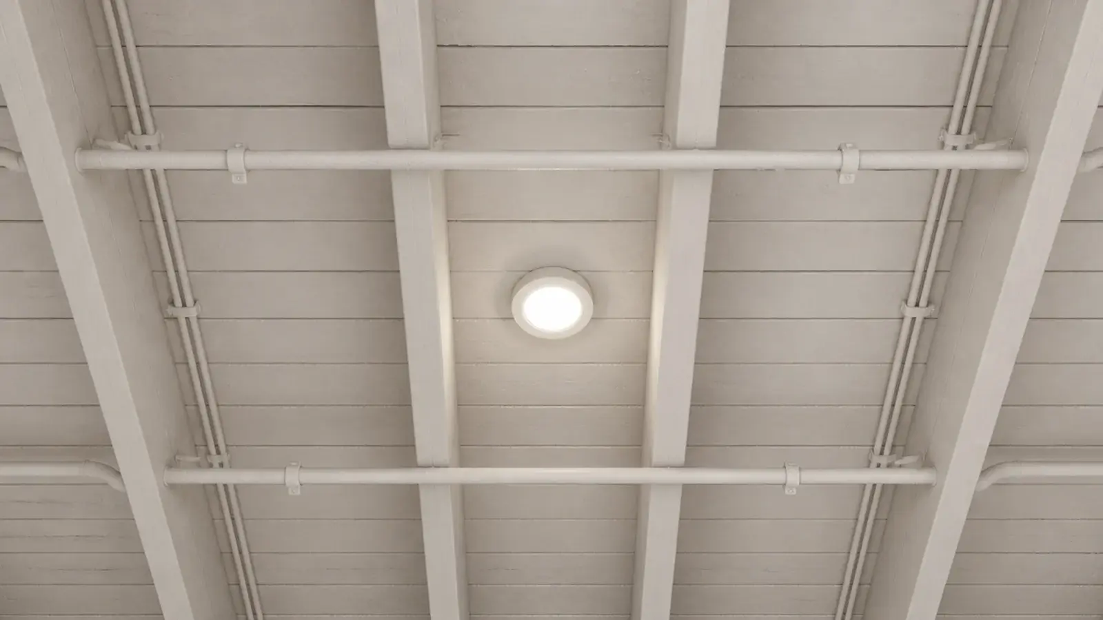 exposed cellar joists pipes and cables all sprayed the same pale tone