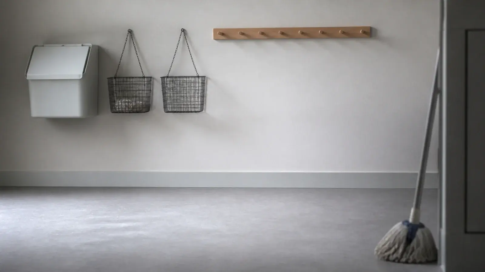 wall mounted bin and hanging baskets above a completely clear vinyl floor