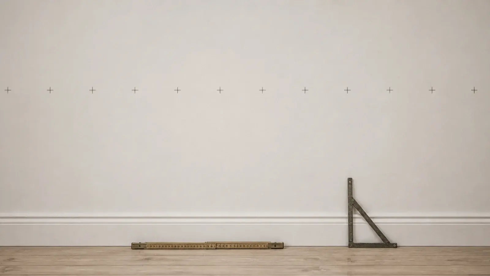 row of pencil crosses marking stud centres along a utility room wall