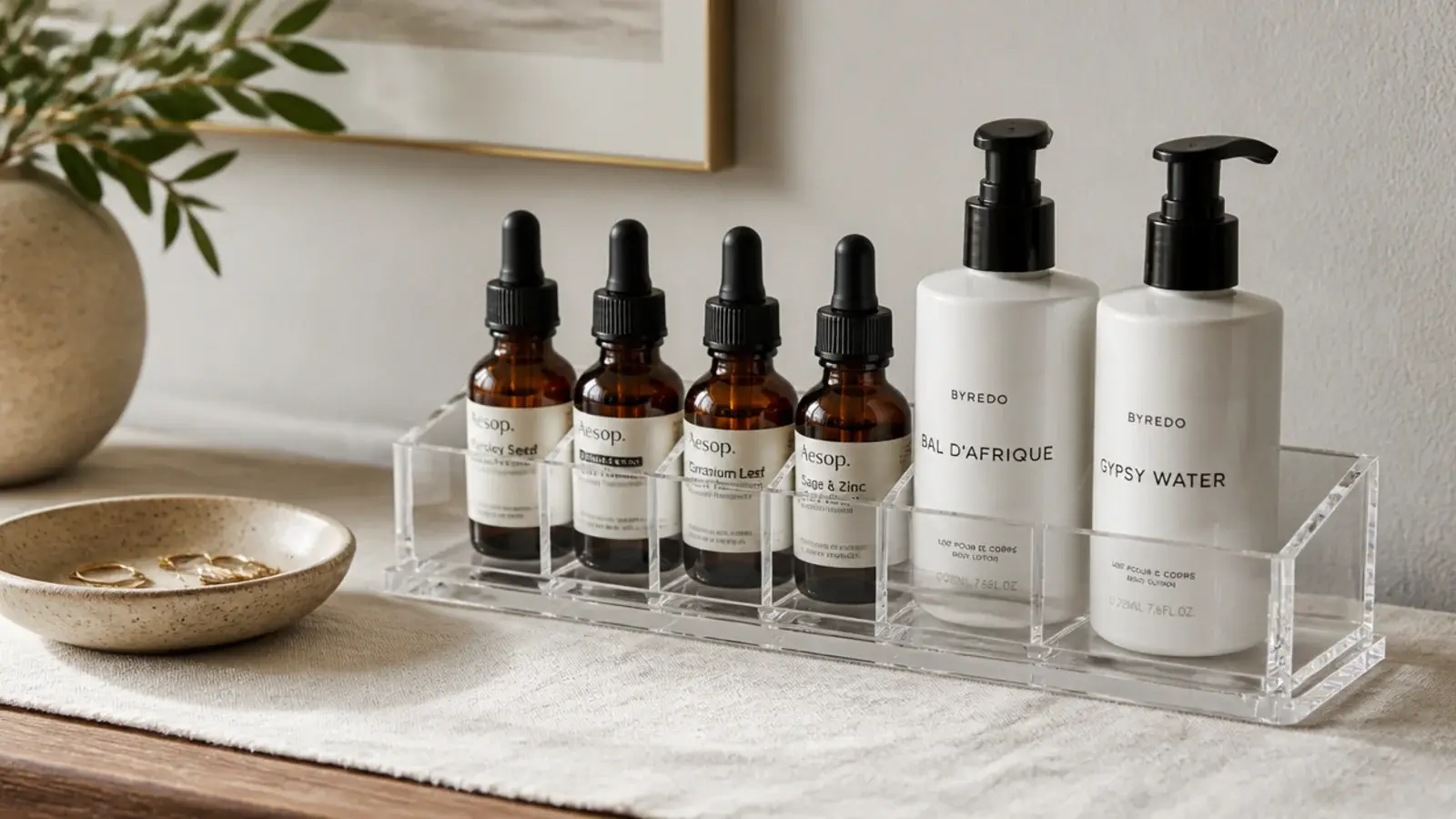 acrylic caddy holding serum droppers and pump bottles standing upright