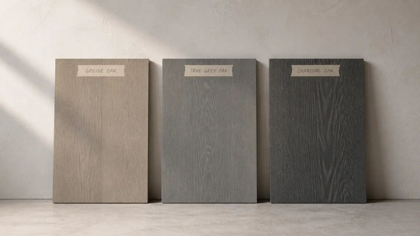 three grey oak samples propped against a wall in changing daylight