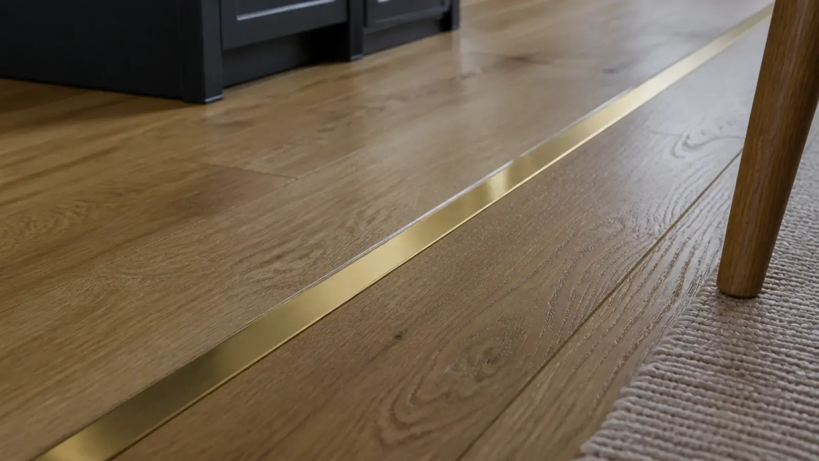 slim brass strip set flush between two areas of oak flooring
