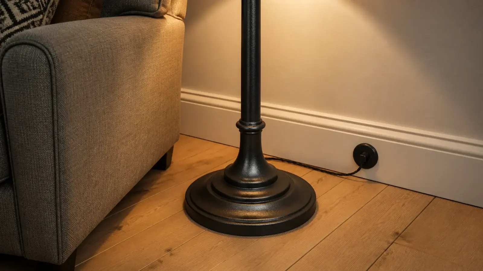 weighted floor lamp base standing steady on bare oak boards