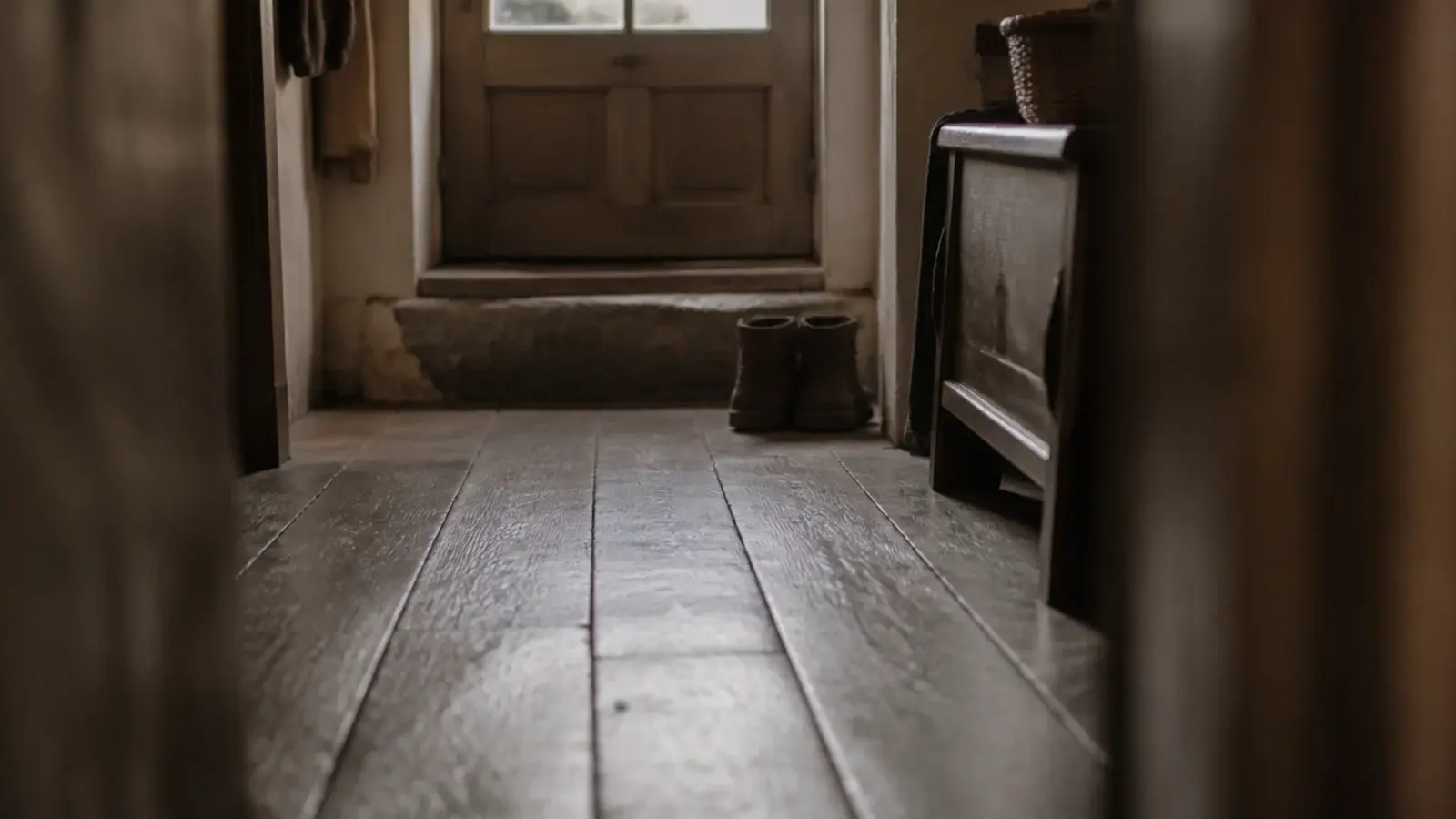 oak boards with softly rounded worn edges meeting in an old hallway