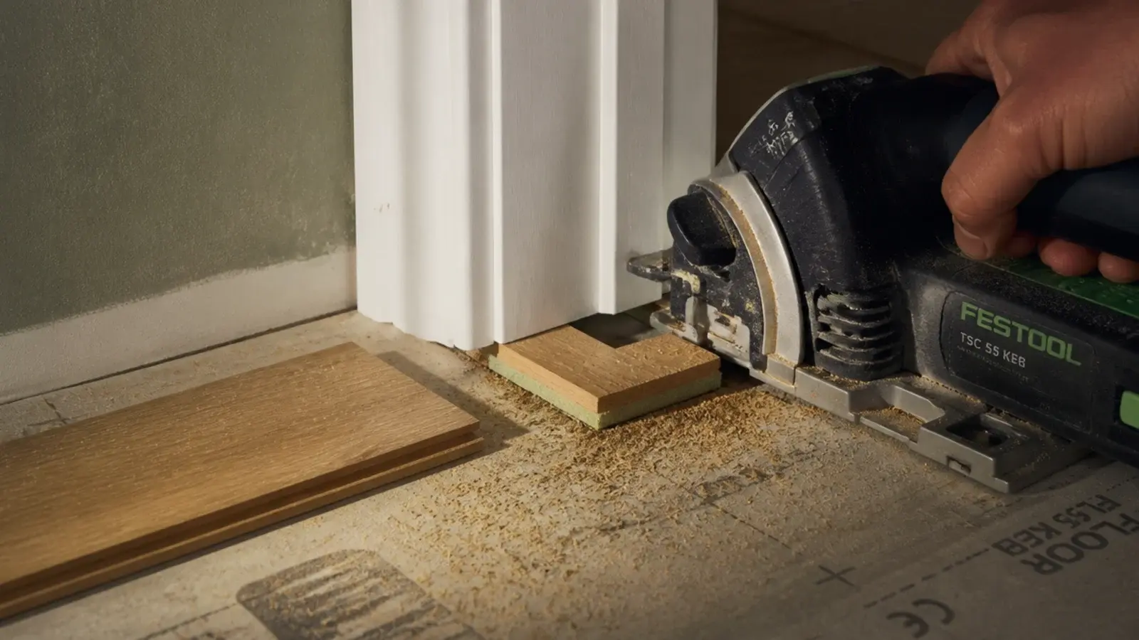 flush saw cutting the base of a door casing using a board offcut