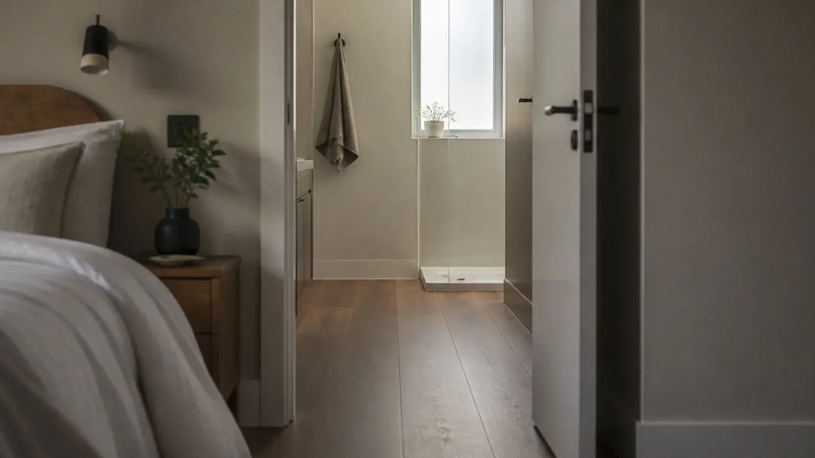 wood effect planks continuing from a bedroom into a small ensuite