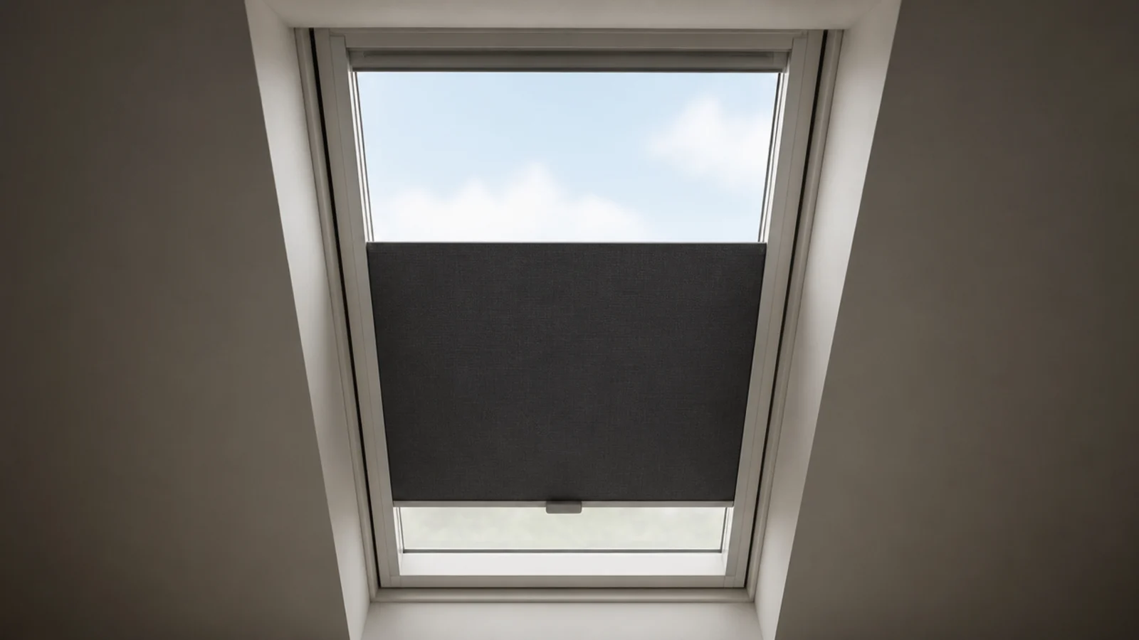 blackout blind running in side channels on an attic roof window