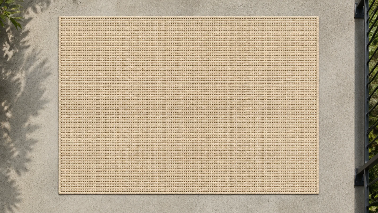 open weave outdoor runner replacing a dense pile rug on balcony concrete