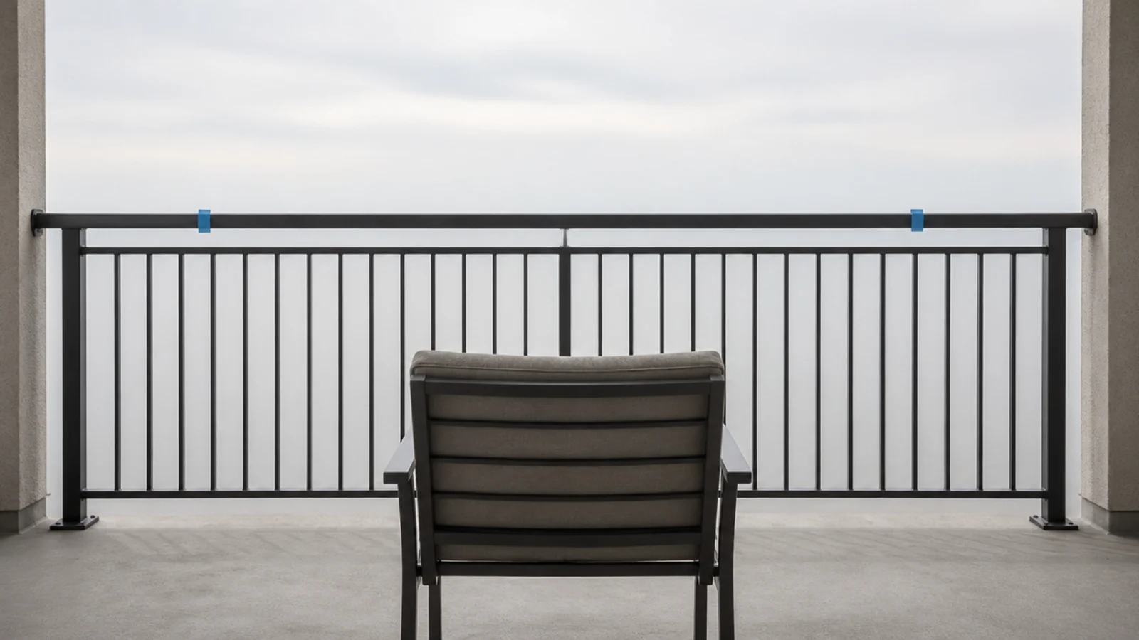 chair placed at a balcony rail with tape marking the exposed section