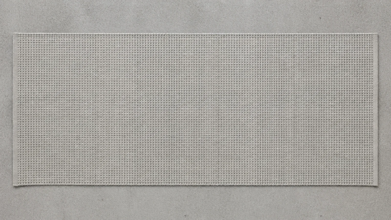 grey toned flatweave runner blending into a concrete balcony floor