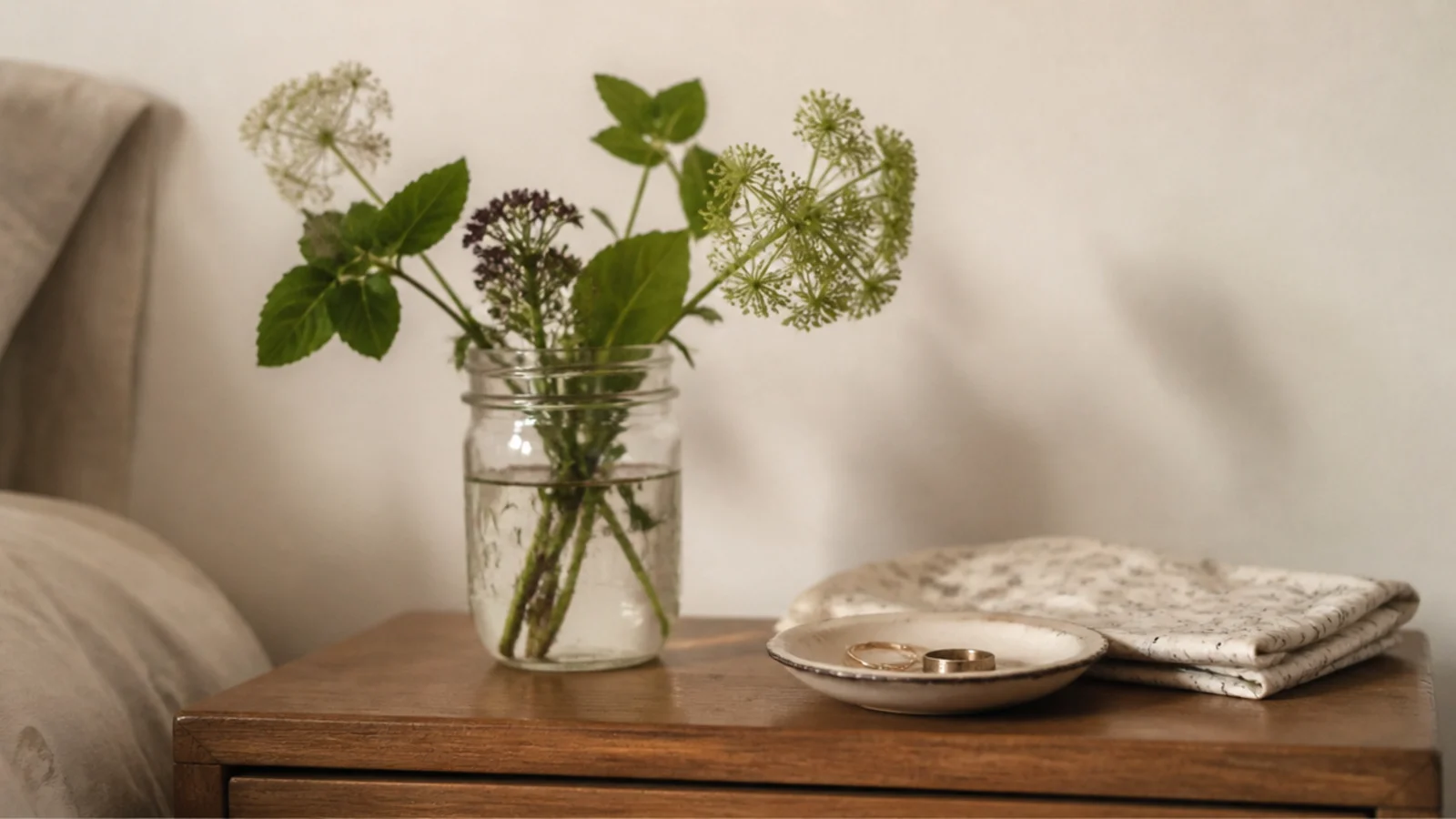 budget bedside table decor ideas using a jar of cuttings and thrifted dish