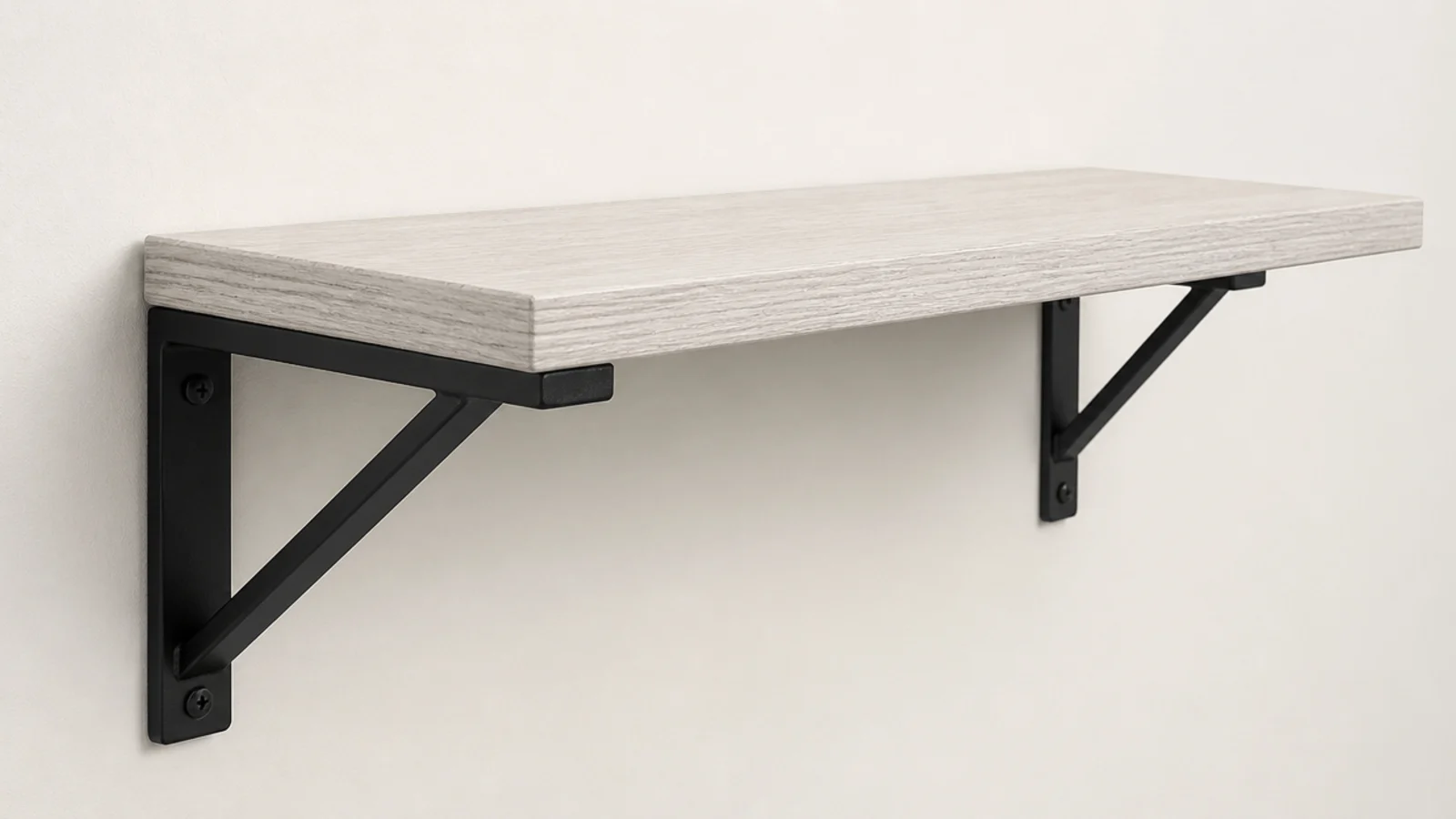 exposed black metal bracket supporting a pale timber bedside shelf