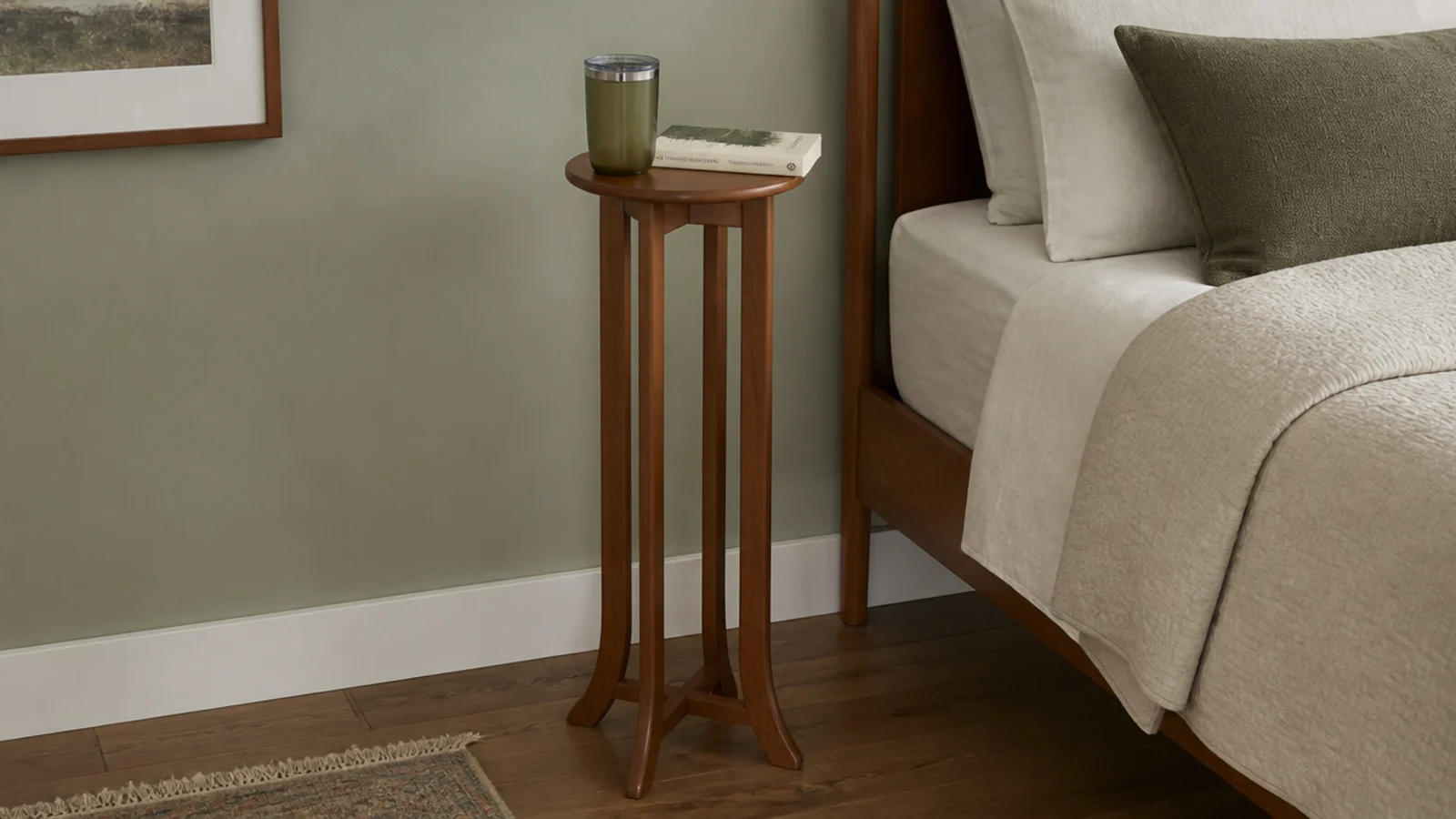 narrow eight inch plant stand repurposed as a tiny bedside surface