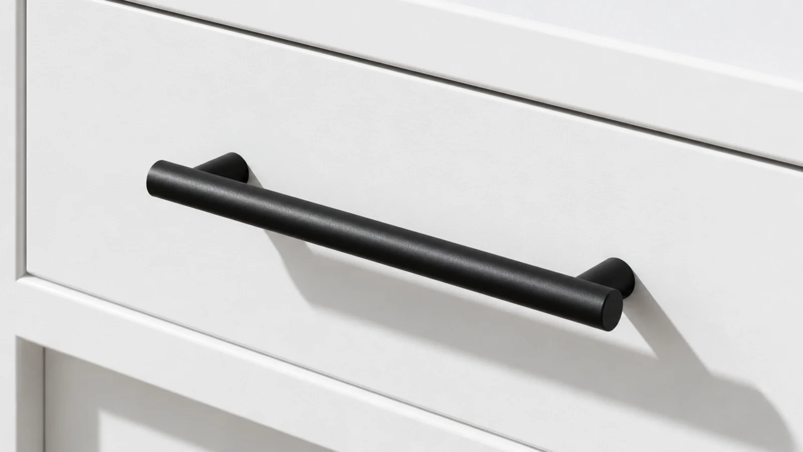 slim black bar pull mounted across a plain white drawer front