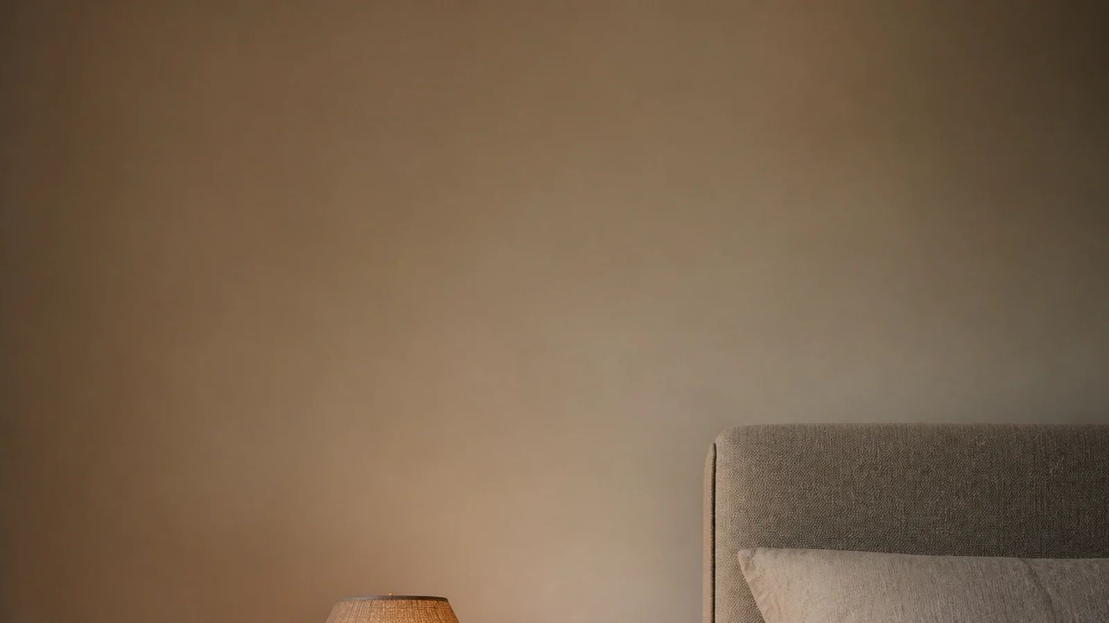 tall view of a wooden bedside table in oak with lamp and open book