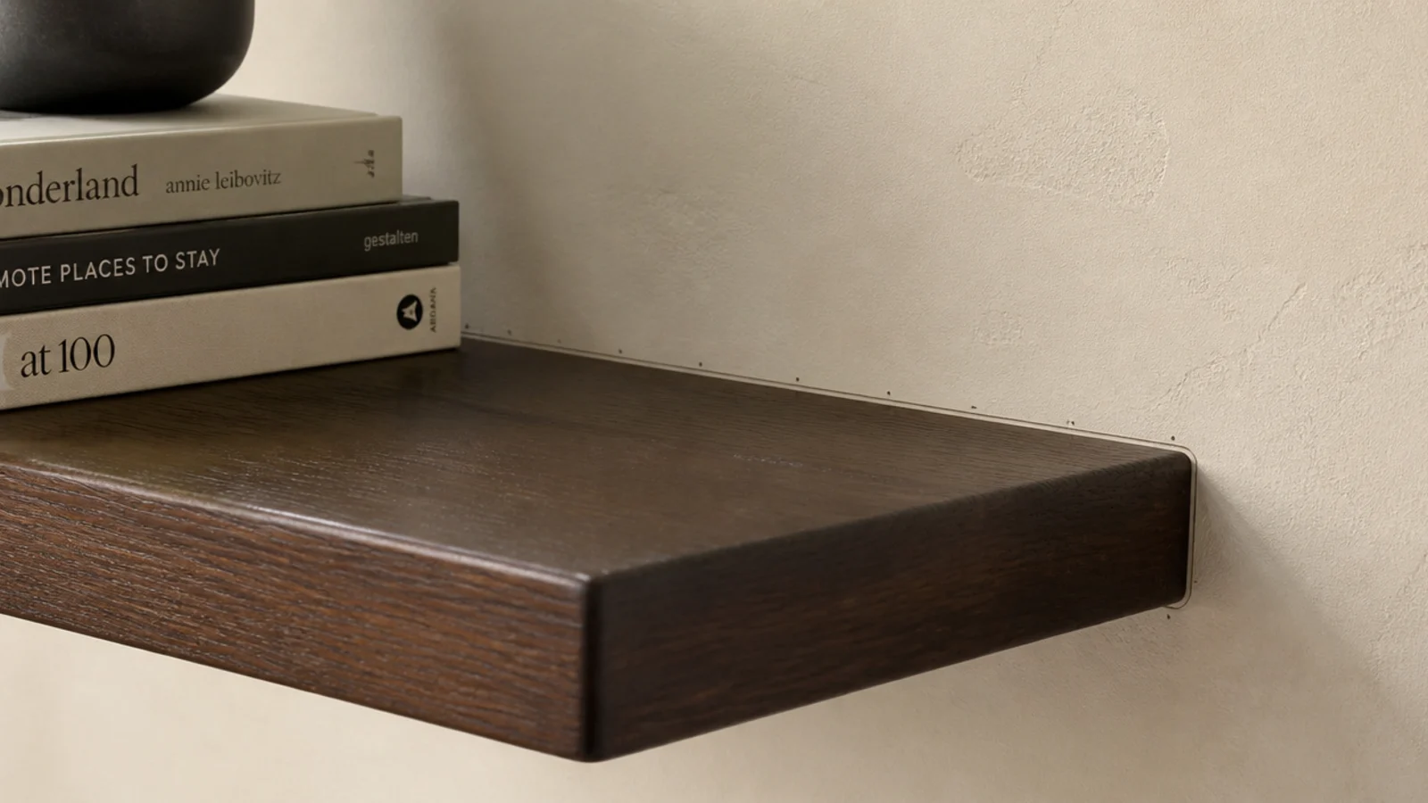 thick shelf on hidden rod brackets appearing to grow from the wall