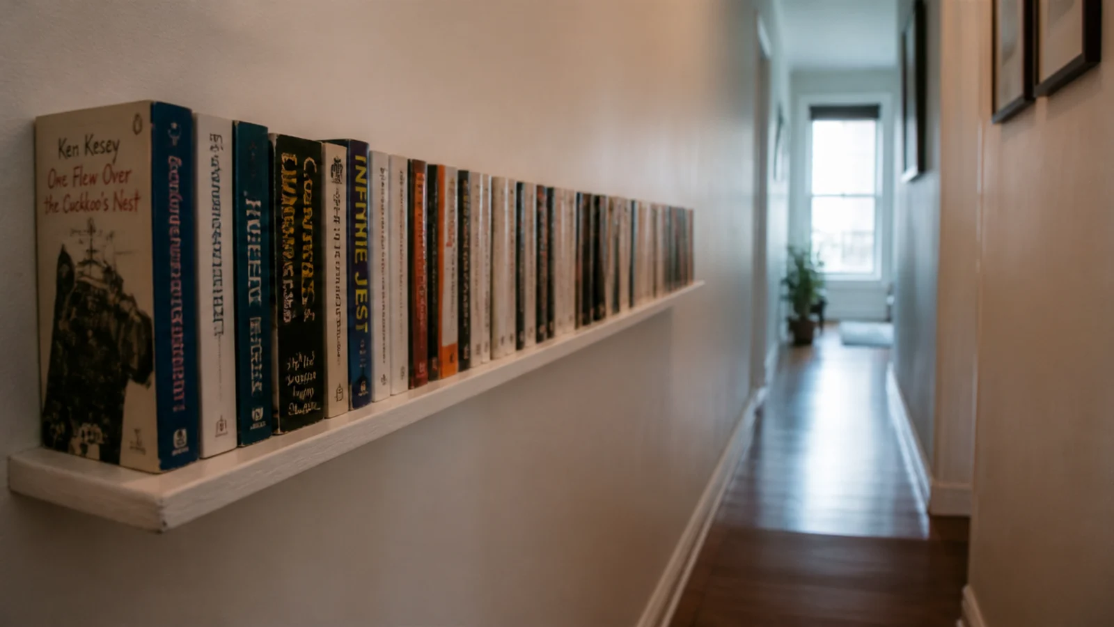 six inch floating ledge of paperbacks running along a hallway wall