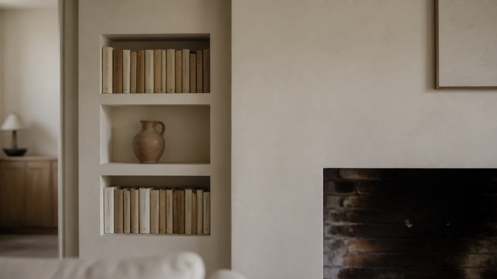 shelving recessed flush into an alcove so nothing protrudes past the wall