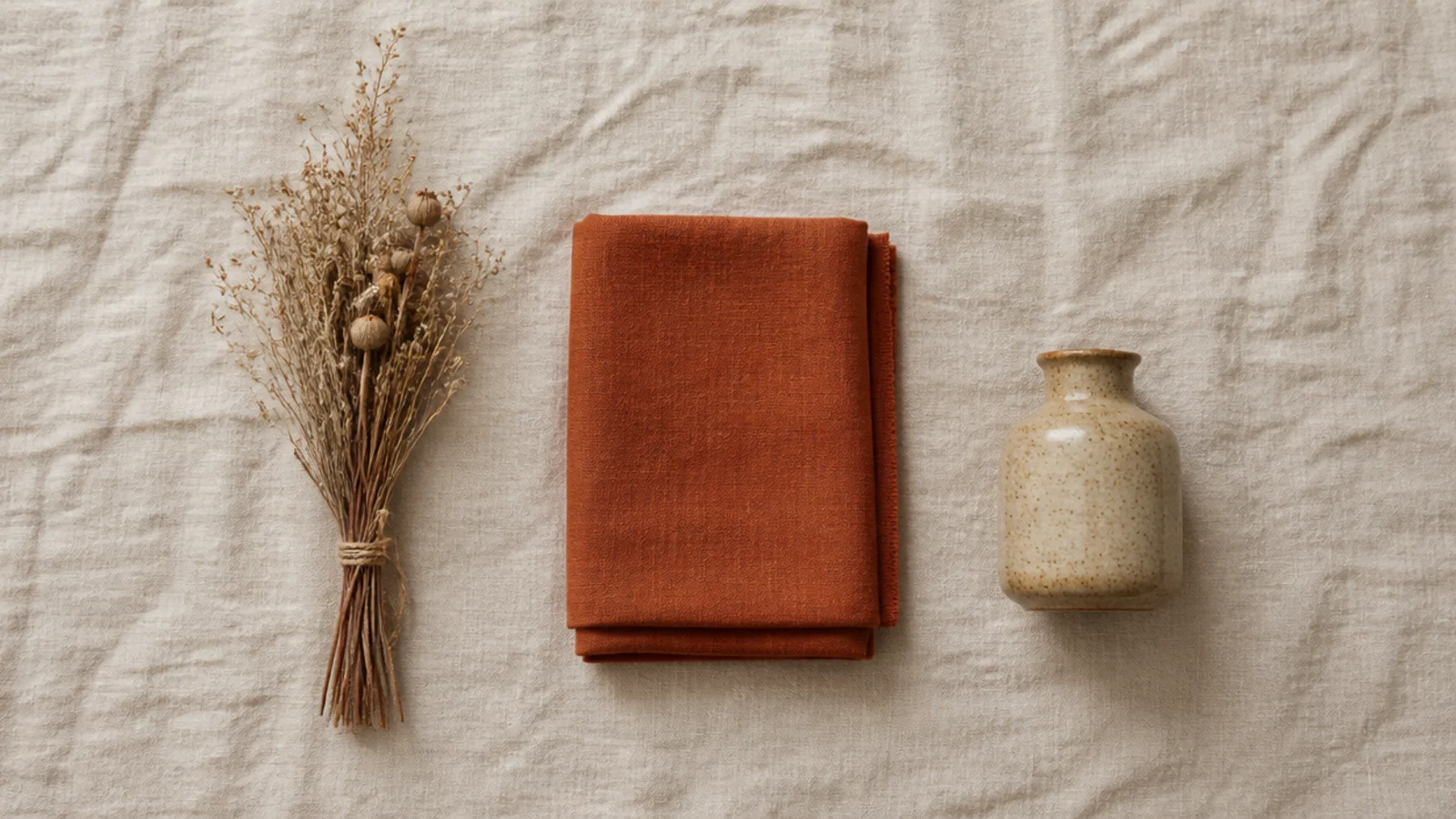 three seasonal objects laid on linen ready to swap into shelves