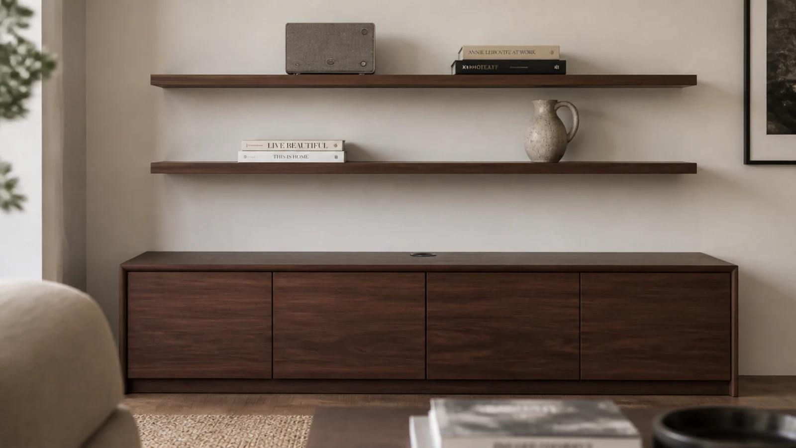 slim floating shelves above a closed walnut media cabinet with speaker and books