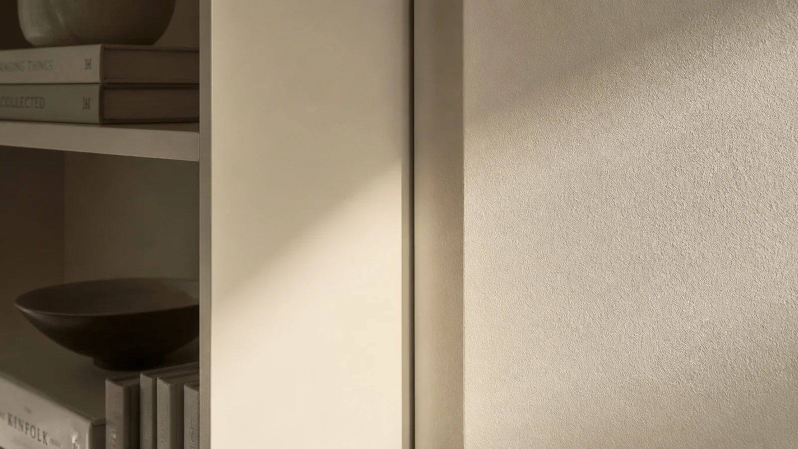 modern built in shelves meeting the wall with a recessed shadow gap