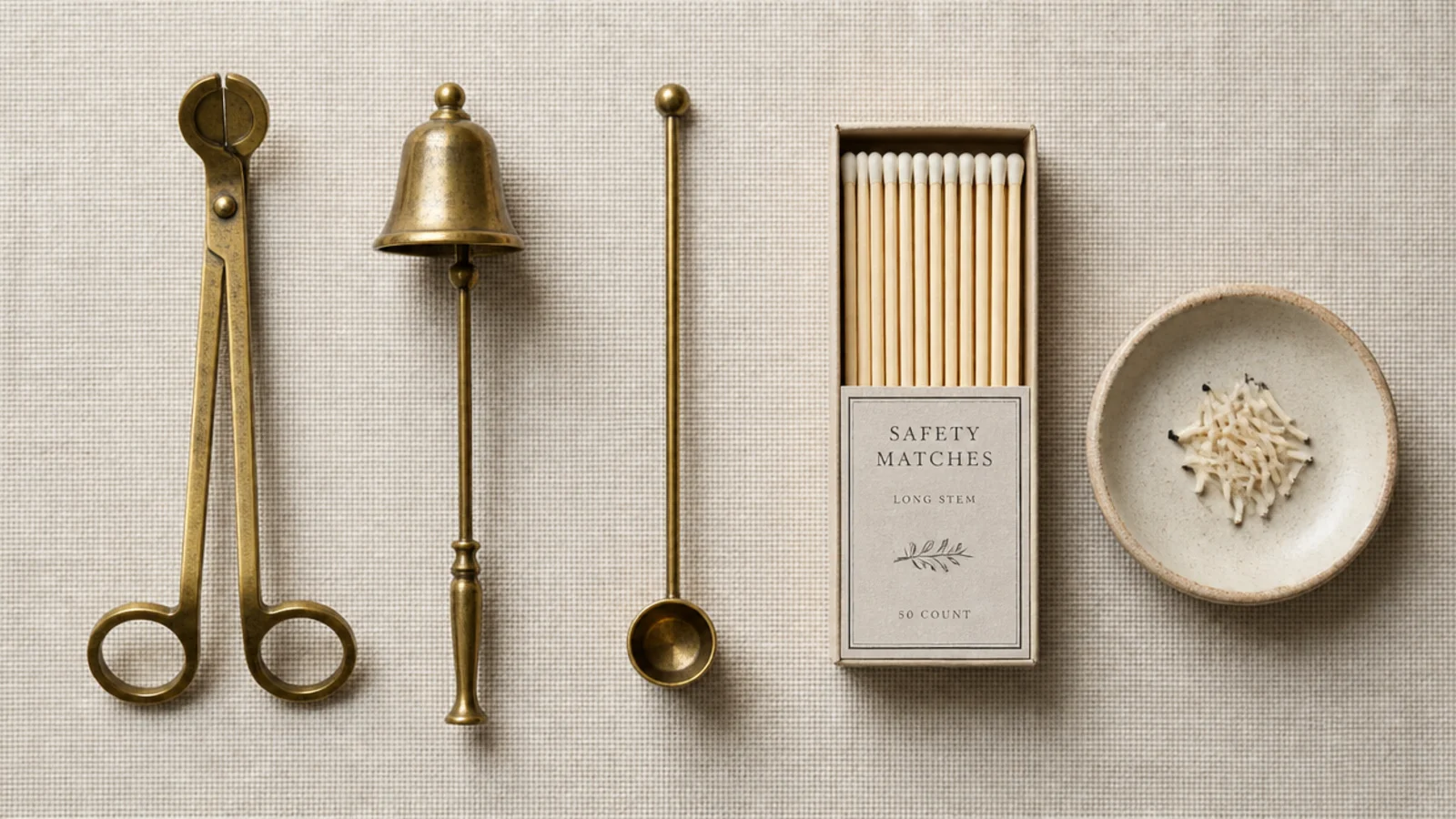 wick trimmer snuffer and matches arranged in a small candle care dish