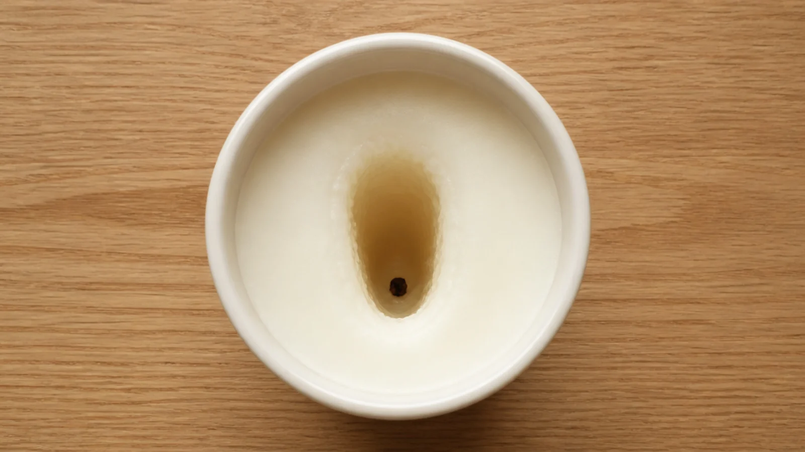 deeply tunneled candle with thick wax walls and a drowning wick