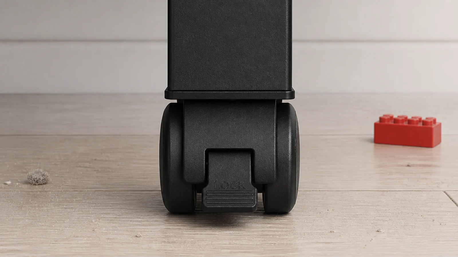 locking caster wheel with the brake pressed down under a table leg