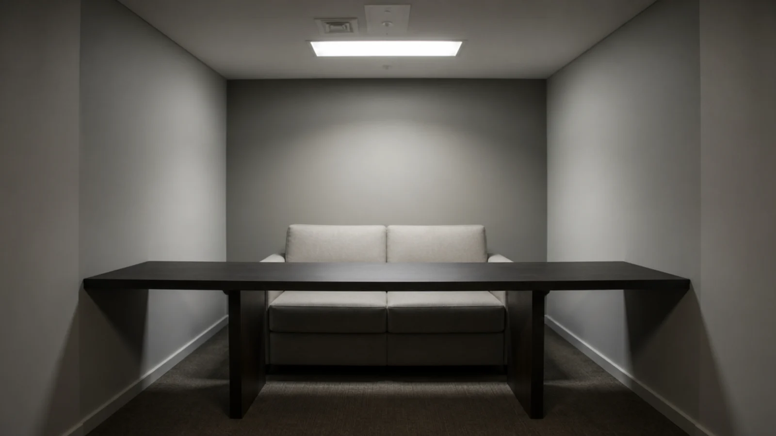 oversized table extending well past the ends of a small sofa