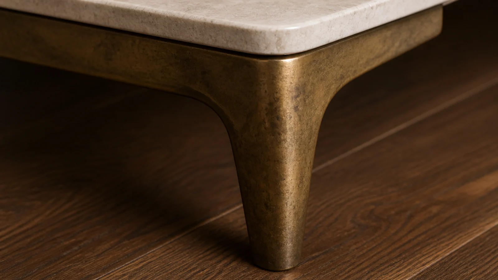 unlacquered brass table leg showing warm patina at the handhold