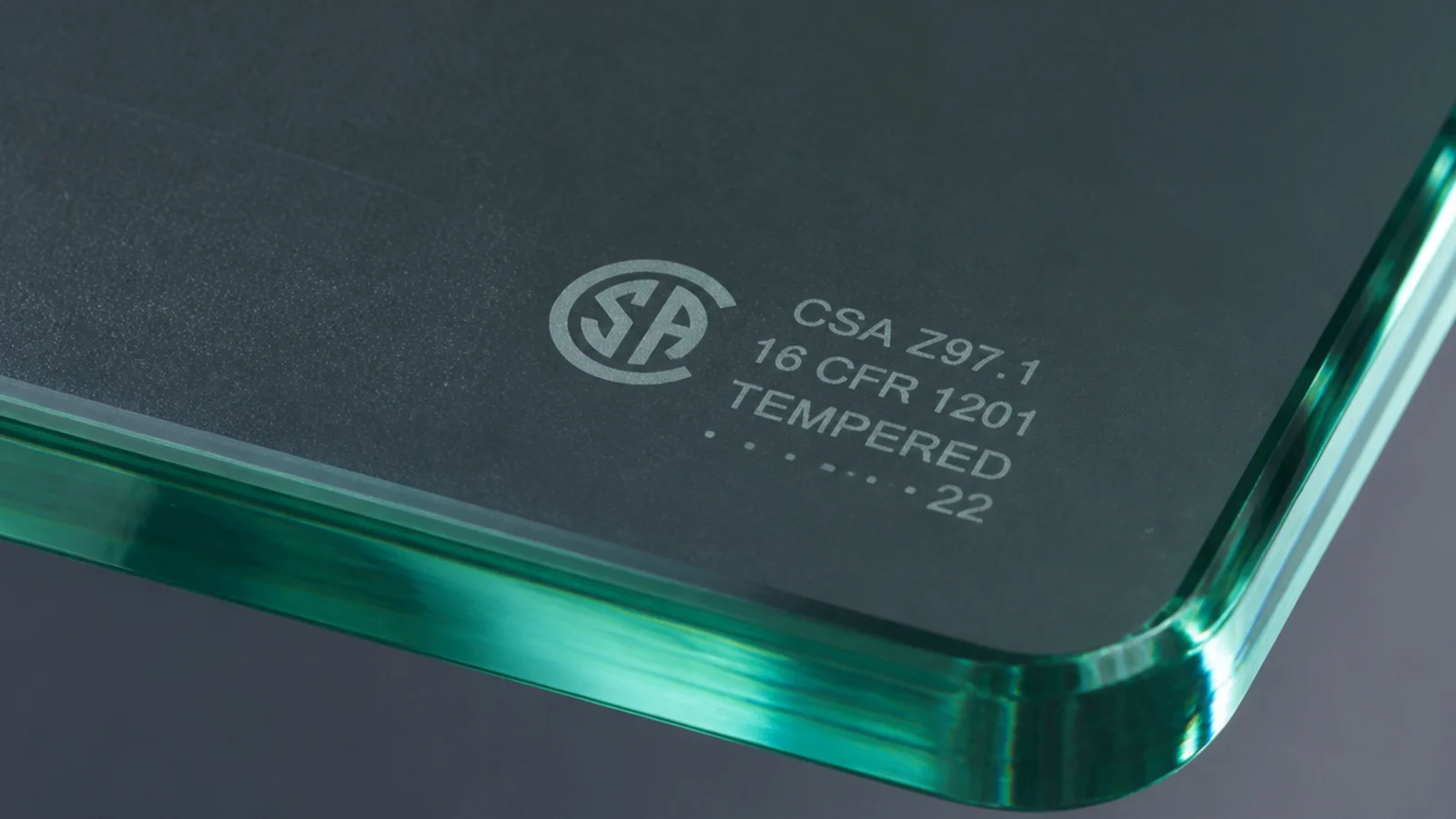 etched safety stamp in the corner of a thick tempered glass panel