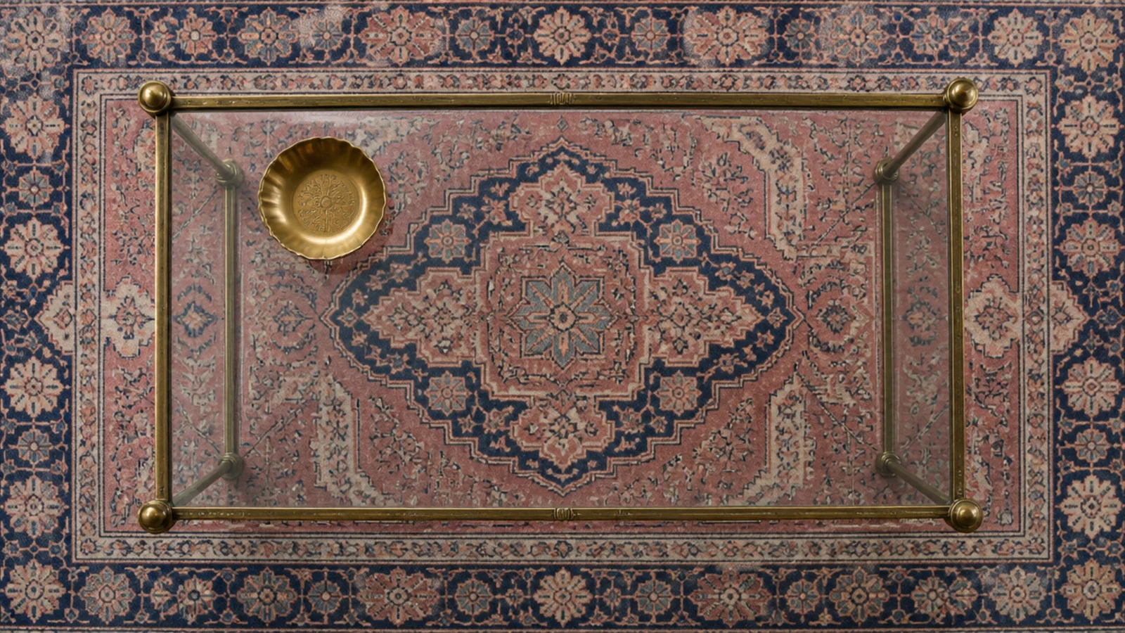 antique rug medallion reading clearly through a clear glass top