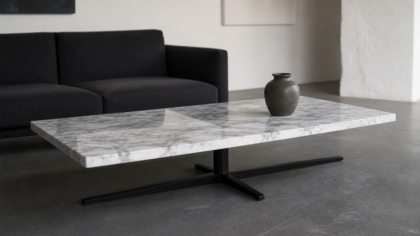 marble top carried on a low blackened steel cross shaped base