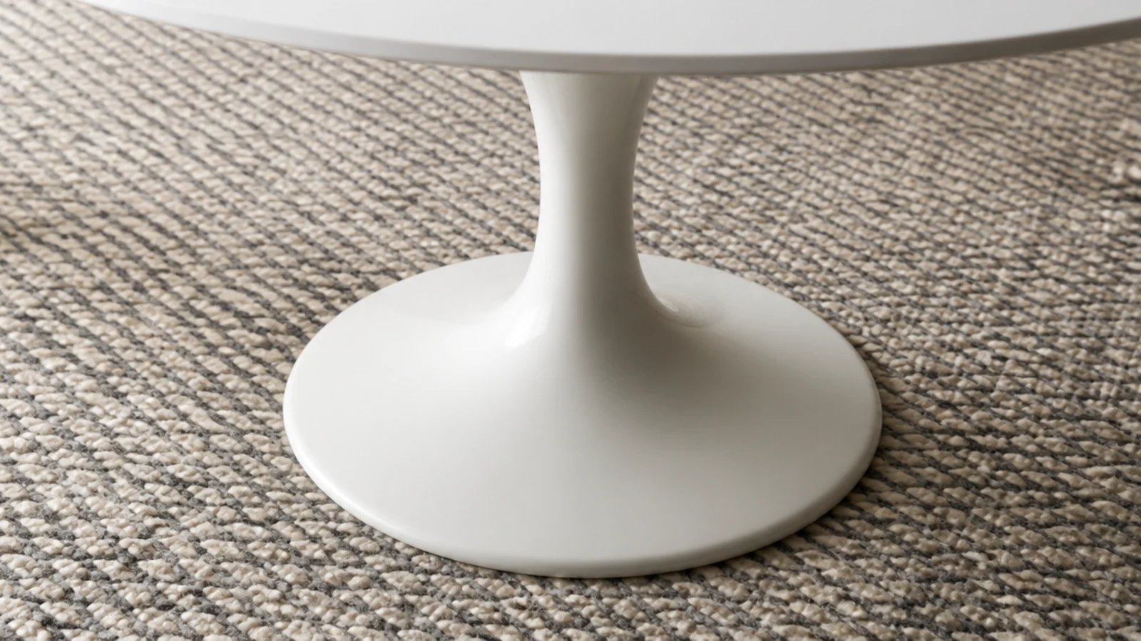 tulip style flared pedestal base standing on a heavy textured rug