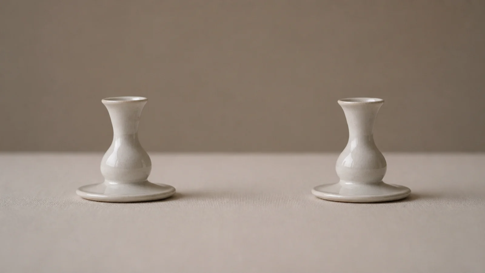pair of matching candle holders placed symmetrically on a table