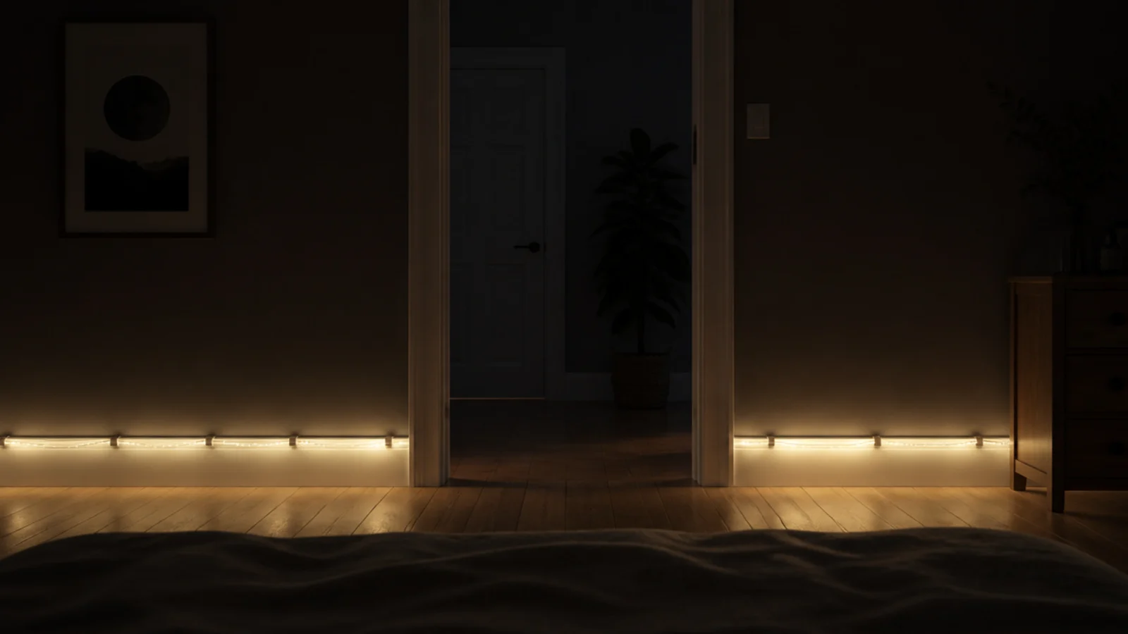warm light line running along skirting board in a dark bedroom