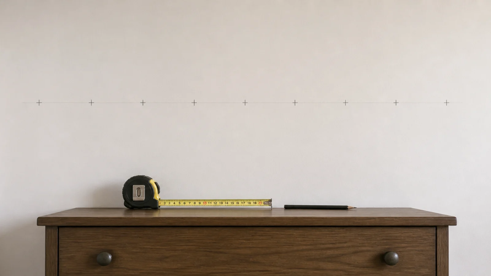 evenly spaced pencil crosses marked along a bedroom wall line