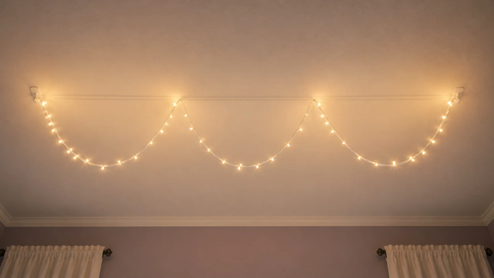 clear nylon line strung across a ceiling carrying a light strand
