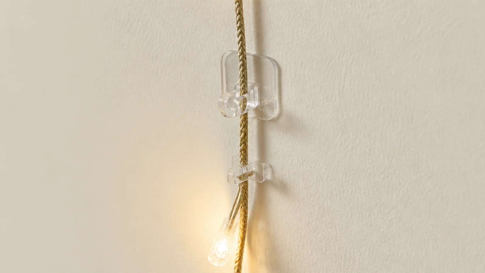 small adhesive hook carrying the weight of a lit garland run