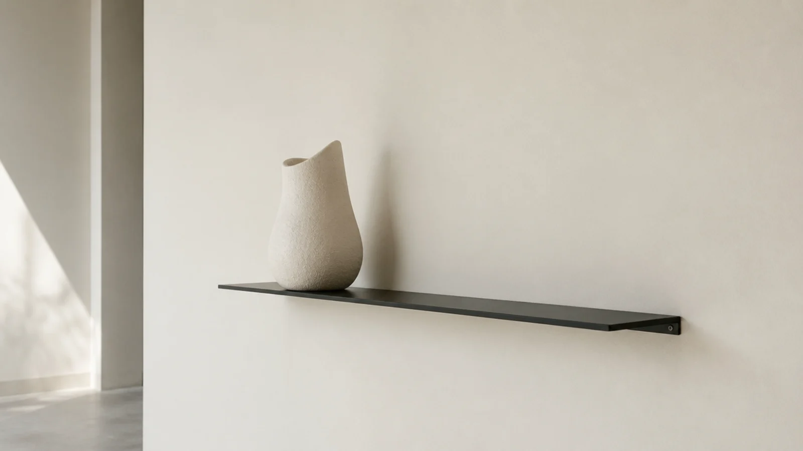 quarter inch black steel plate shelf reading as a thin dark line