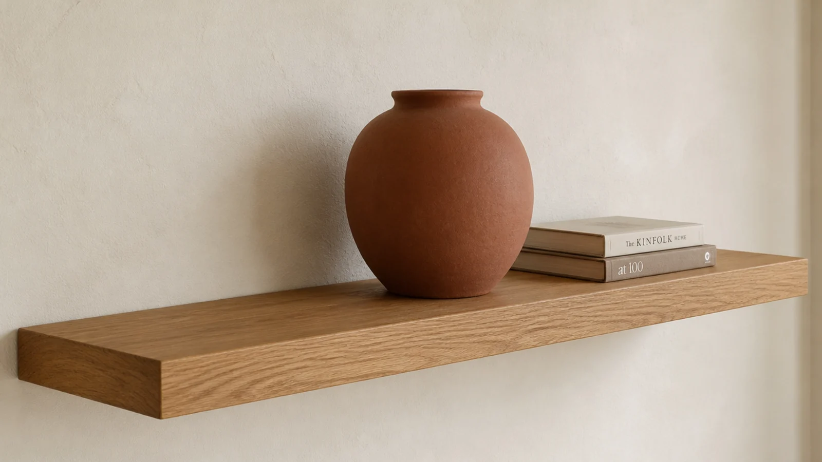 large stoneware vessel placed off centre on a floating oak shelf