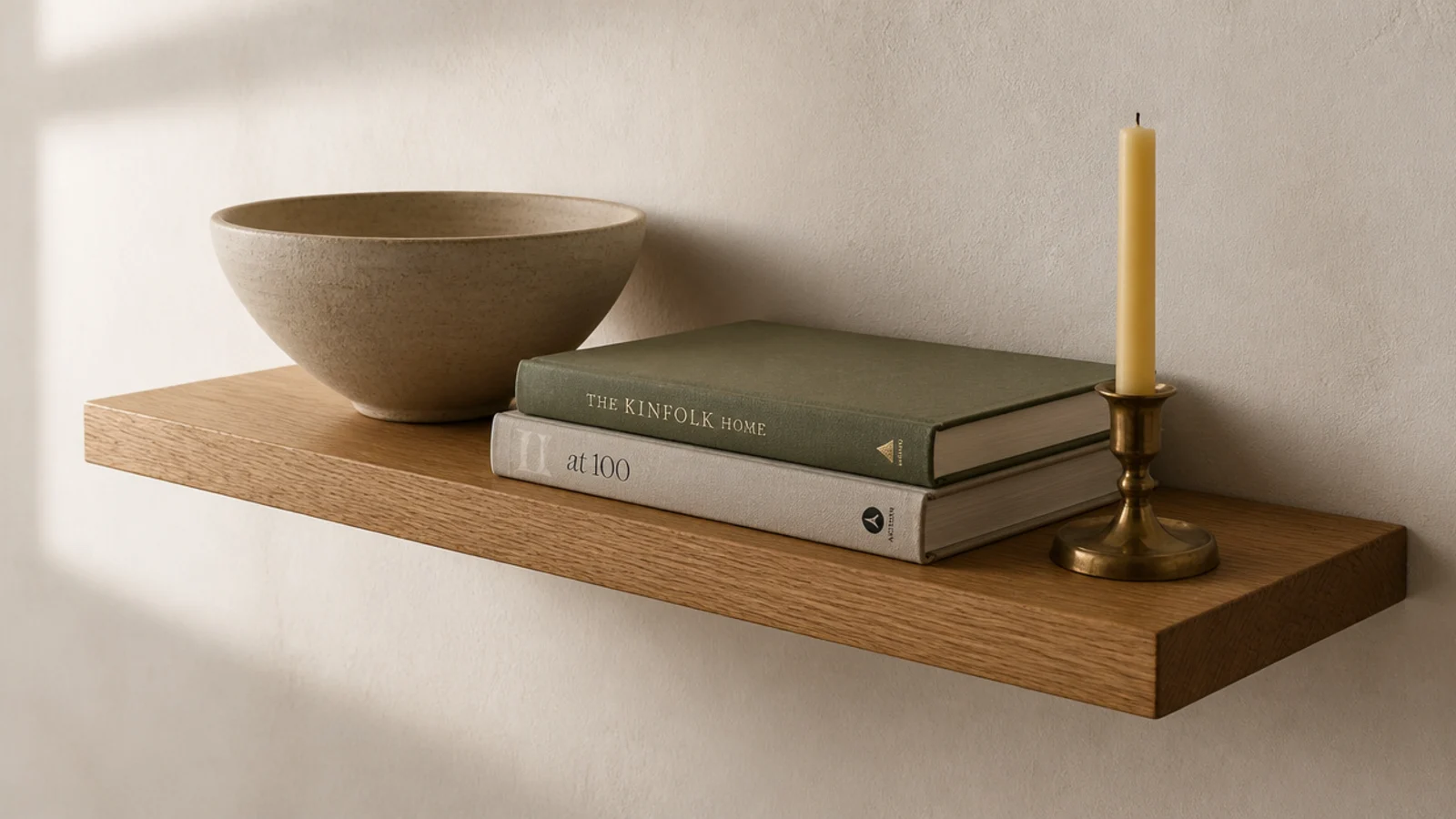 single 24 inch oak floating shelf mounted level on a plain cream wall