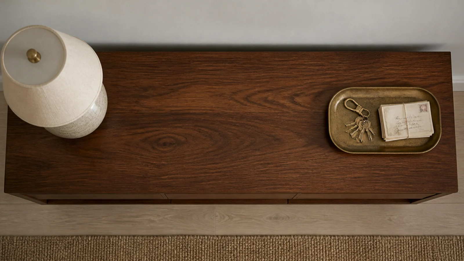 brass tray placed opposite the lamp on an entryway console top